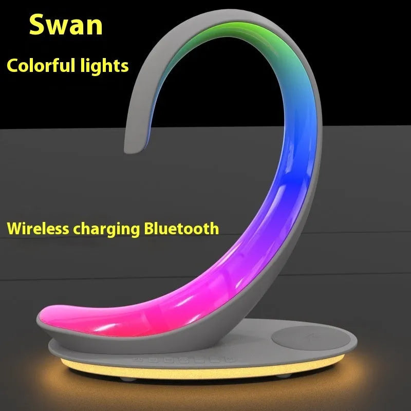White swan decorative light with wireless charging pad and Bluetooth speaker emitting colourful illumination
