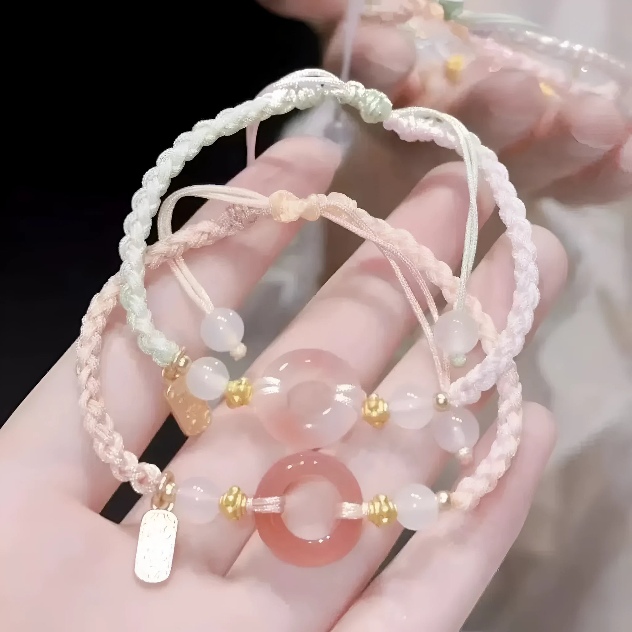 Women's woven bracelet with peach blossom minority ethnic design and peace buckle closure
