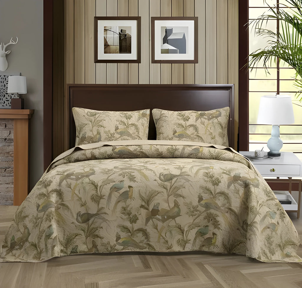 Blue American floral and bird patterned cotton quilted bedspread set on a bed, showing the 230x250 cm size
