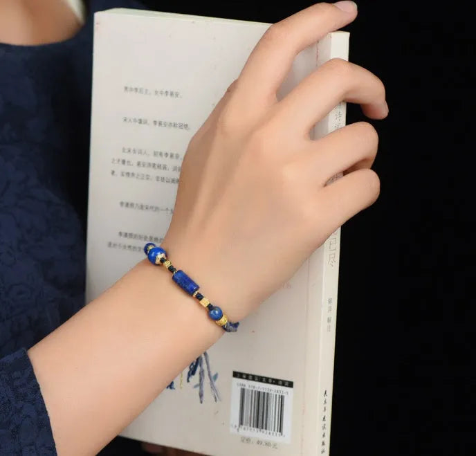Close-up of a hand-woven flexible wire bracelet for women with a Lapis Lazuli stone accent.