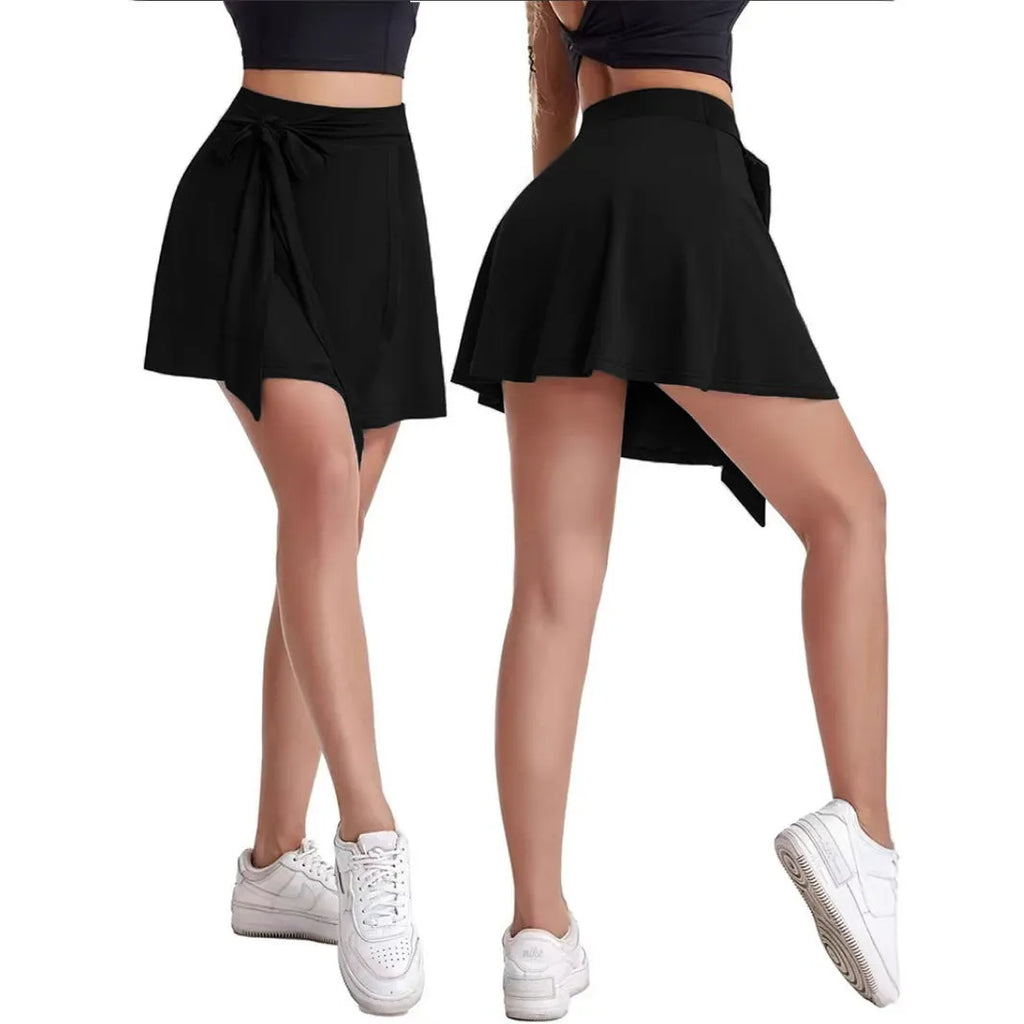 Black thigh-length sports skirt with built-in shorts, high waist design, and shoulder strap details
