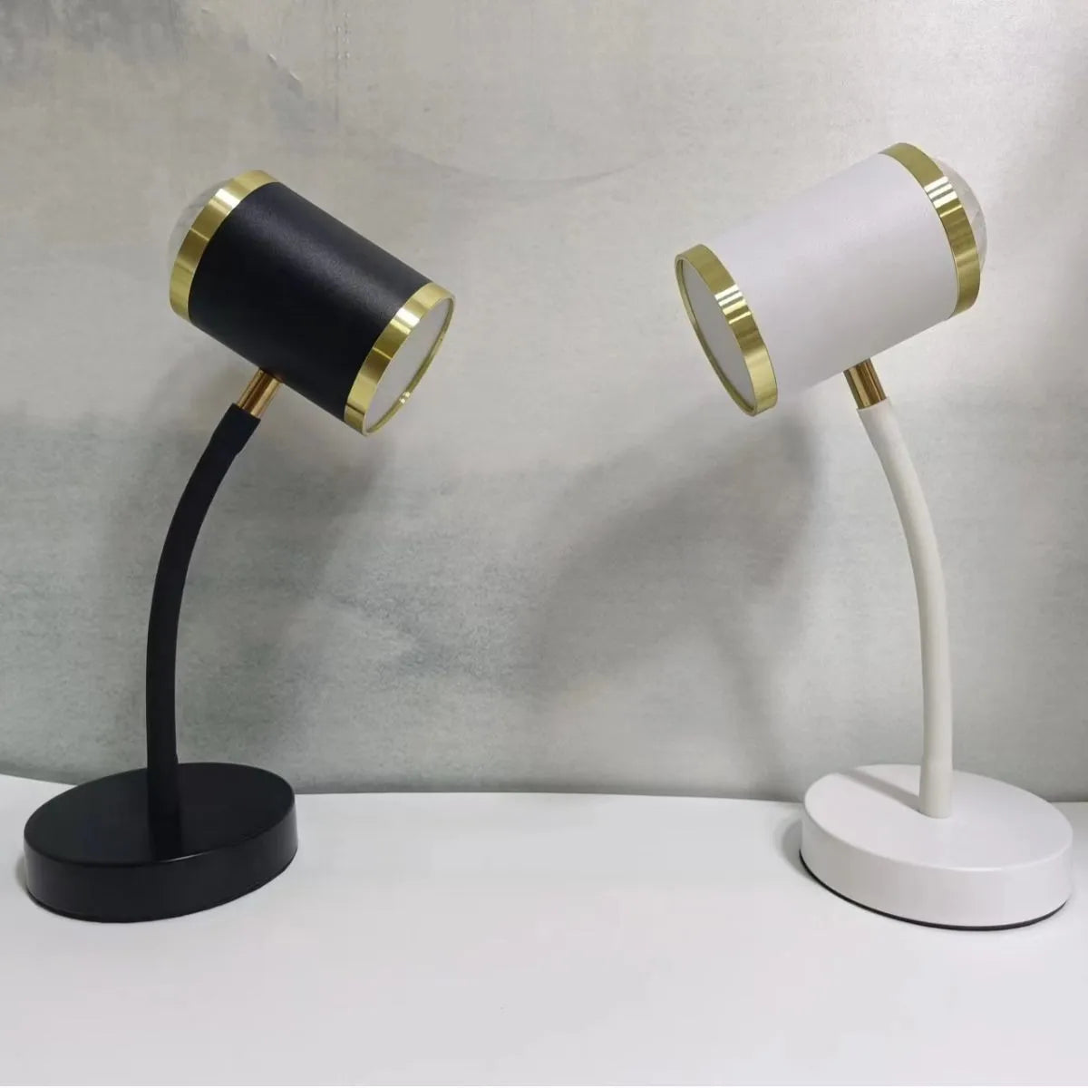 Black and white double-headed photography studio lamp with adjustable arms and metal base