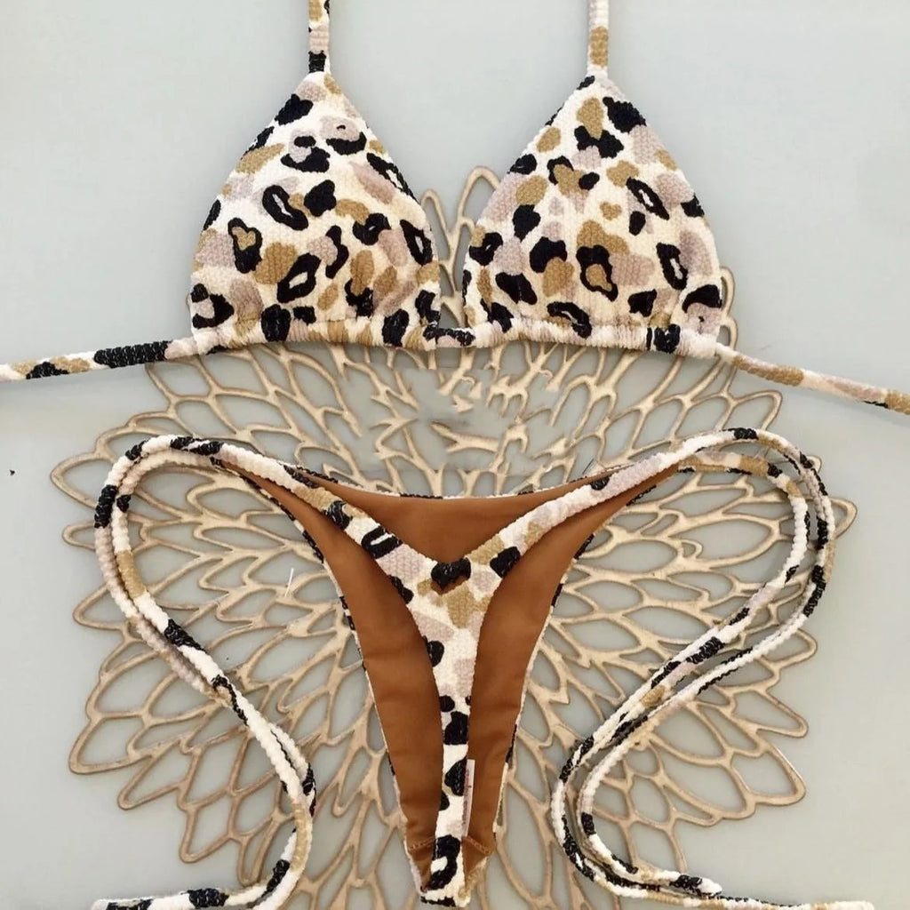 Women's printed bikini swimsuit on a hanger, showing briefs style with quick-drying fabric and cotton lining.