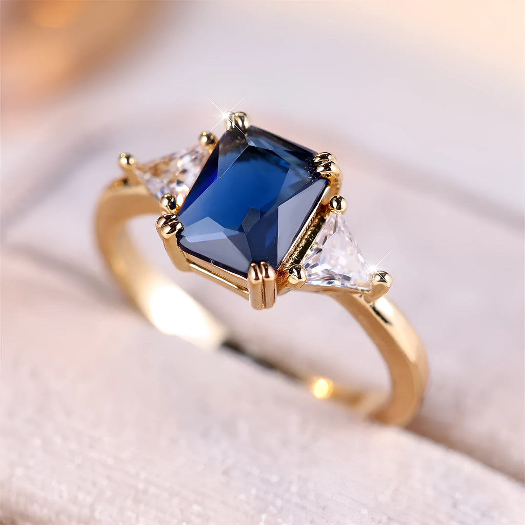 Rectangular copper ring with gold sapphire blue finish for women, shown in size options 6 to 13