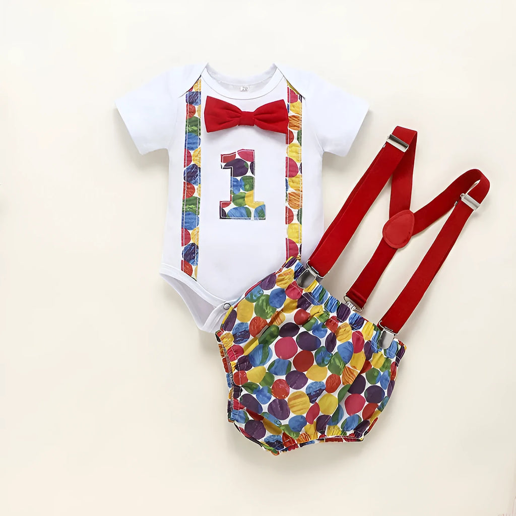 Baby wearing a blue cotton romper with shorts, a bow, and dinosaur print details.