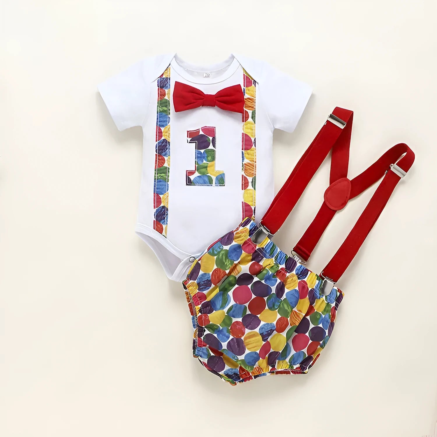 Baby wearing a blue cotton romper with shorts, a bow, and dinosaur print details.