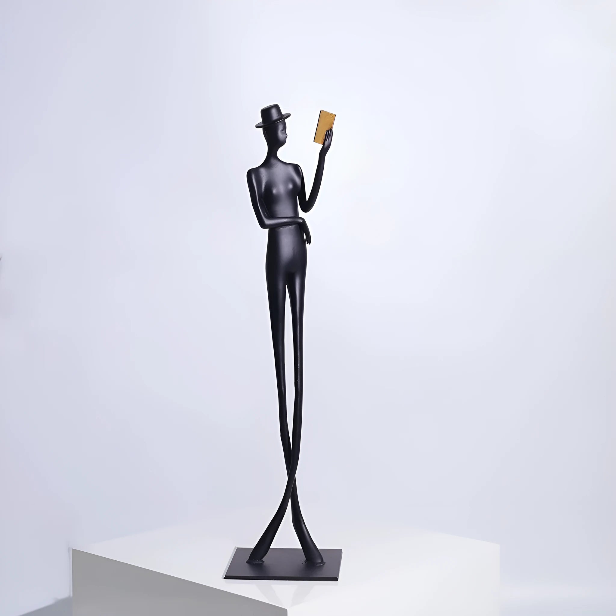 Black cast aluminium reading woman desktop sculpture measuring 51 cm tall