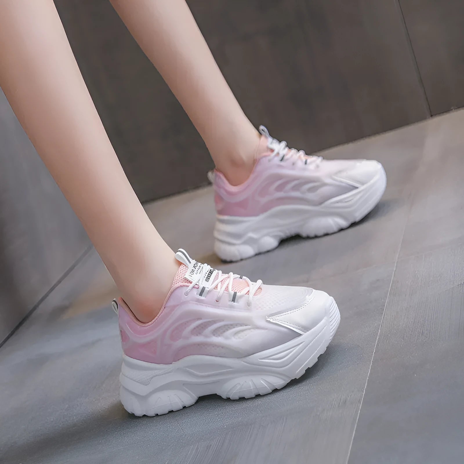 Women's pink satin lace-up casual shoes with round toe on a white background.