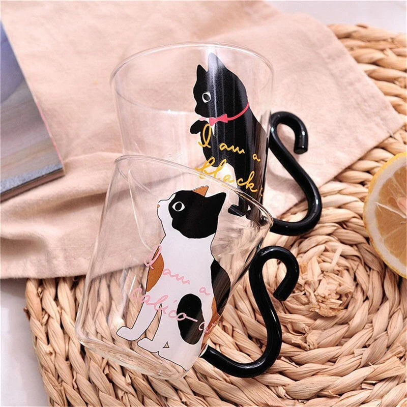 Adorable cat-shaped glass mug with a playful cat tail handle, perfect for coffee, tea, and juice lovers