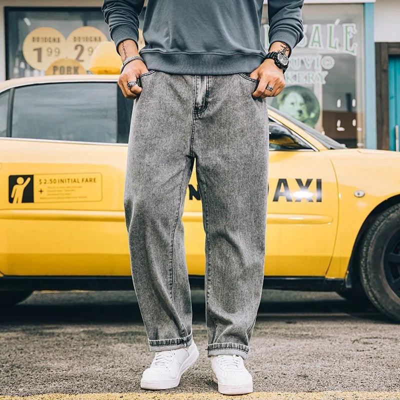 Men's loose straight-cut cotton jeans in dark blue, shown in a casual setting