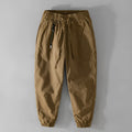 Men's Army Green cotton overalls with drawstring waist and banded ankles laid flat.