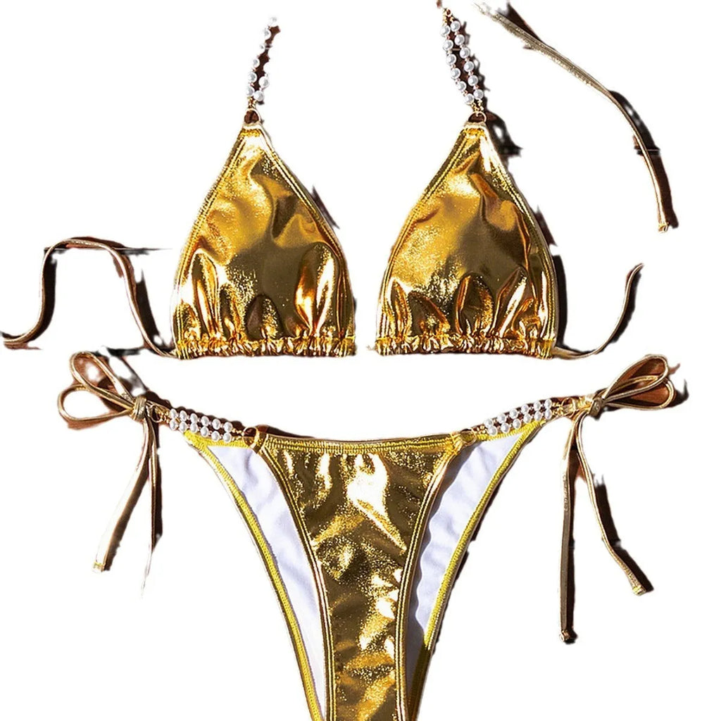 Gold halter neck bikini top with lace-up front and pearl chain, paired with brief-style bottoms