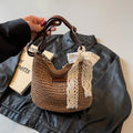 Women's woven straw messenger bag in khaki colour with shoulder strap