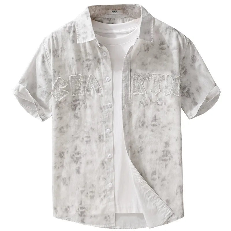 Men's grey white loose fit short sleeve cotton cardigan with a hanging dyed print, shown on a hanger.