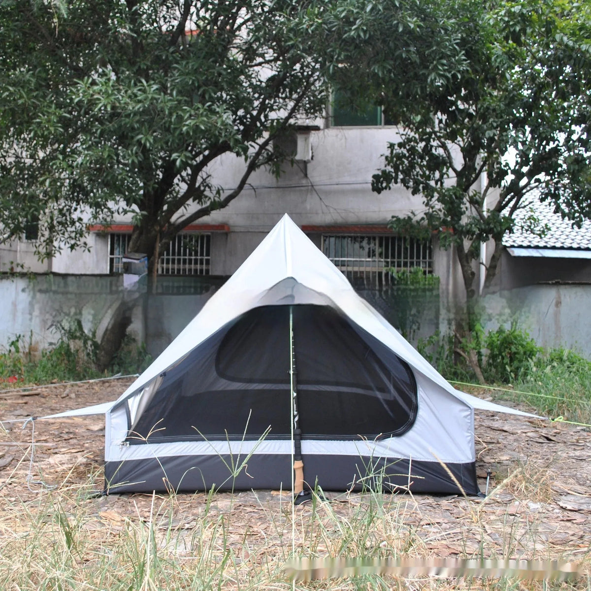 Brown or white A-line pole-free cabin tent for 2-3 people with hiking cane setup.
