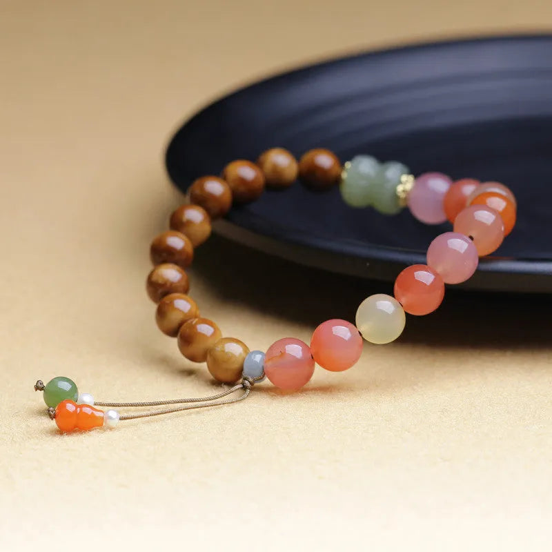 Handmade agate bracelet with 8mm diamond-shaped beads showing natural persimmon colour elements