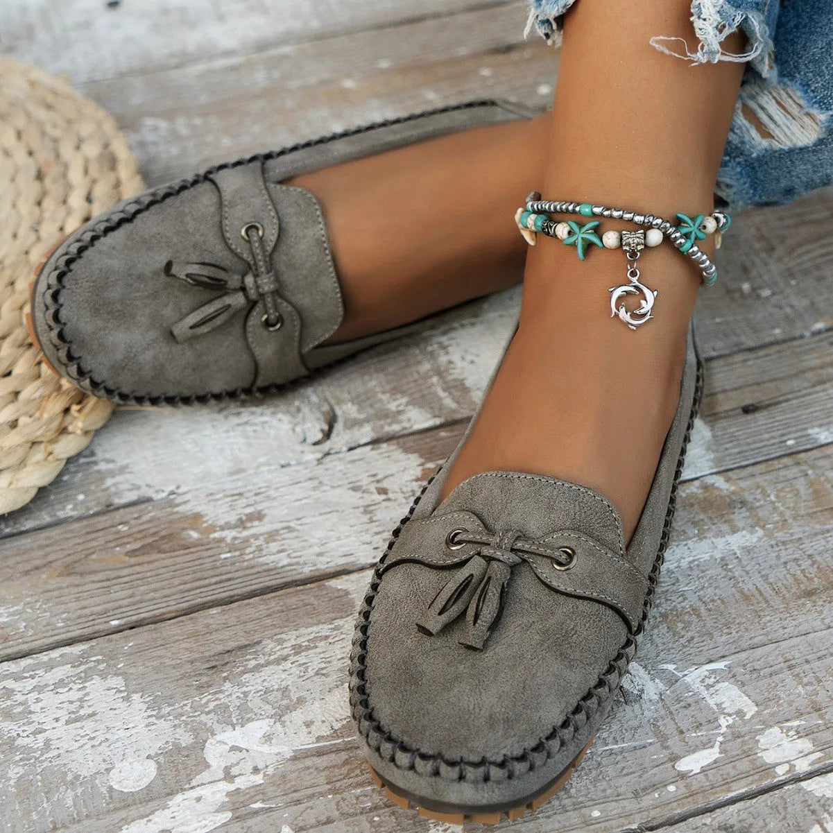 Women's suede flat shoes with a bow, shown in pink, apricot, grey, and blue colour options.