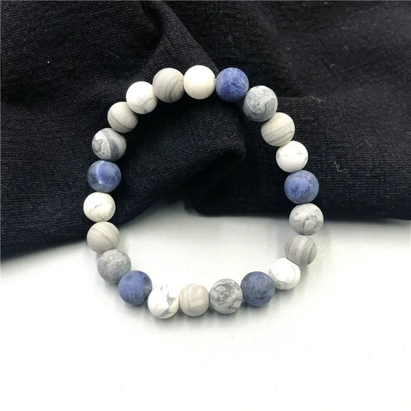 Handmade planet stone U-shaped bracelet with universe wind design on a wrist.