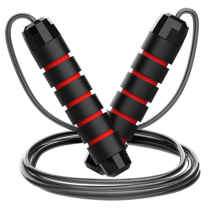 Steel wire jump rope with black PP handle on a dark background for fitness training