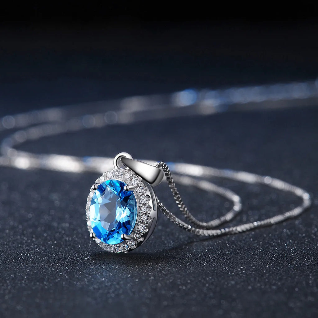 Geometric sterling silver jewellery set with blue topaz gems including earrings, ring, pendant and necklace