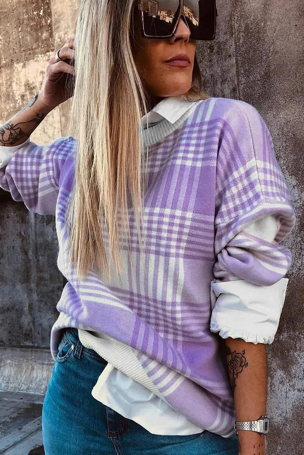 Lilac plaid print loose sweater with ribbed cuffs and hem on a hanger.