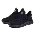 Men's low-top black mesh sneakers with stripe pattern and flat plastic sole on a white background.