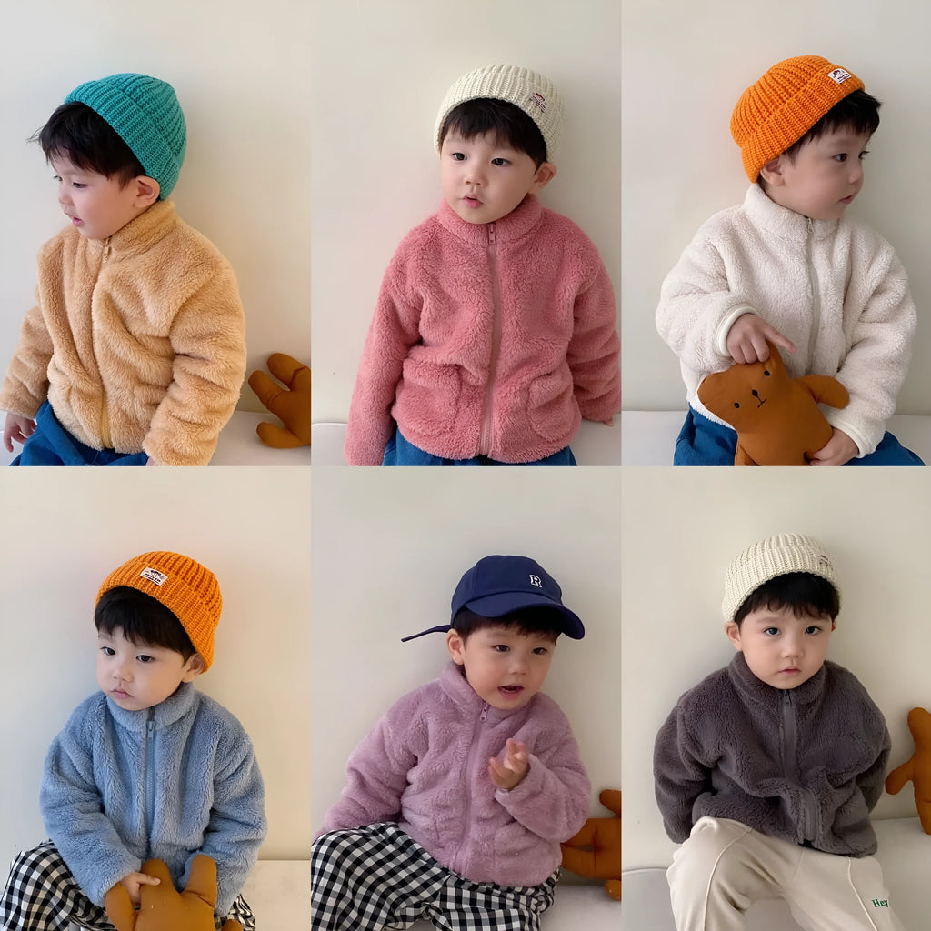 Child wearing a blue sherpa fleece zip-front winter coat with a high collar and front pockets.