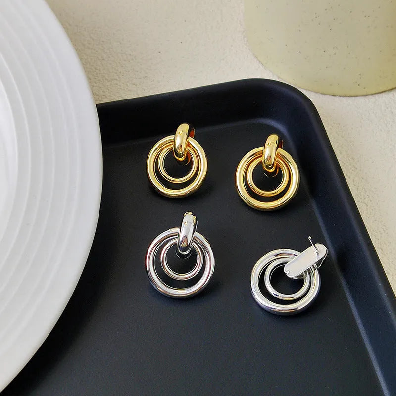 Geometric irregular round ring earrings in electroplated gold colour with exotic style mixed material construction