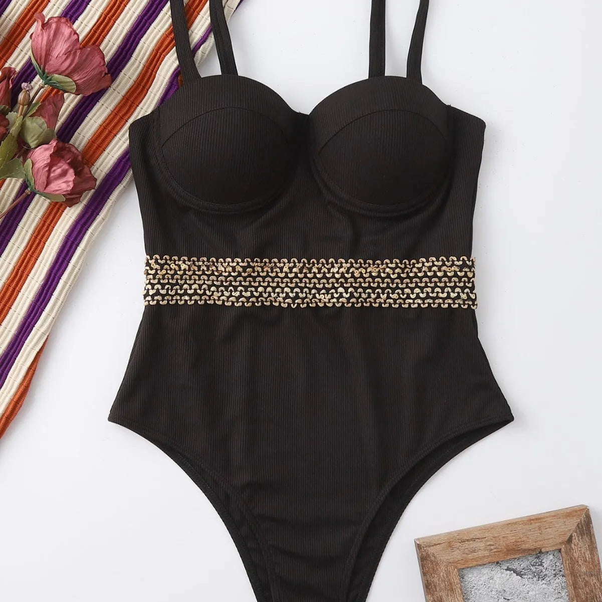 Black one-piece women's swimsuit bikini with adjustable shoulder straps on a white background.