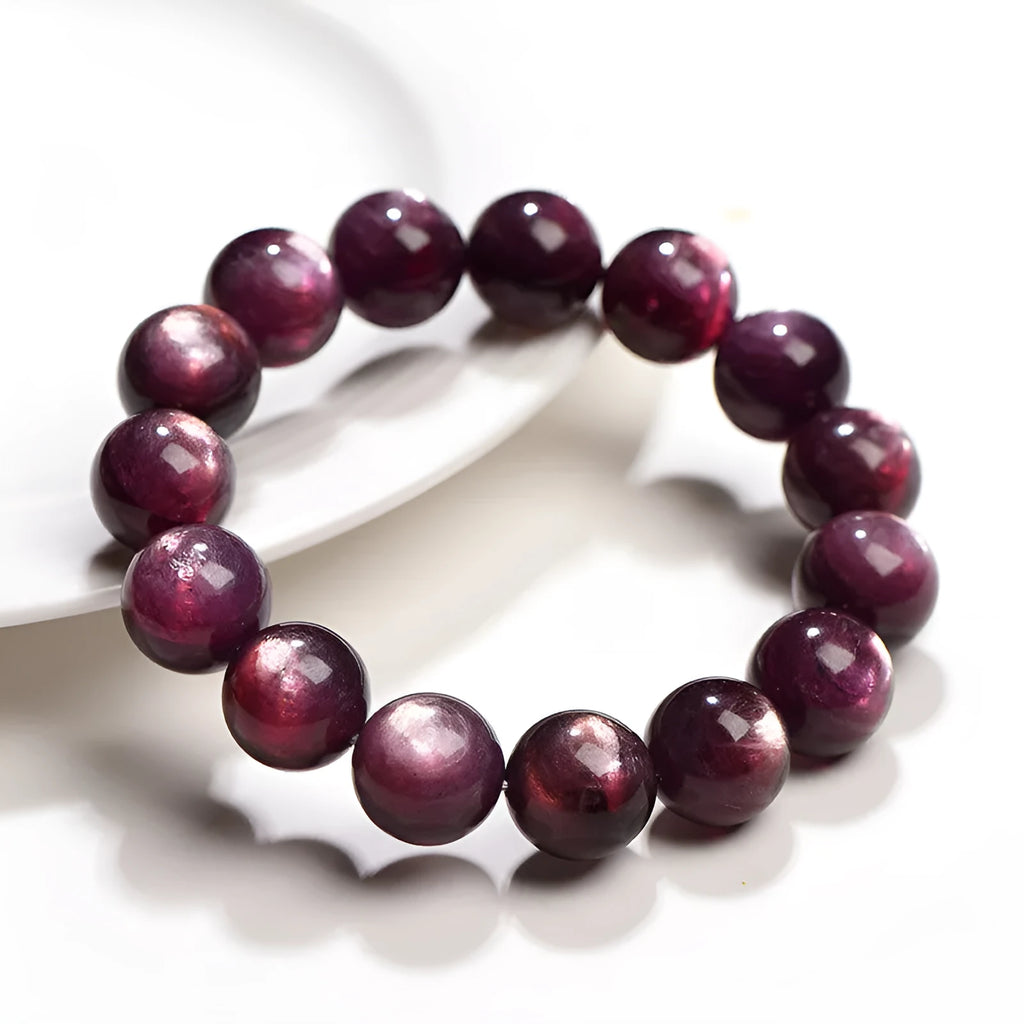 Natural purple lepidolite crystal round bead bracelet on a white background.