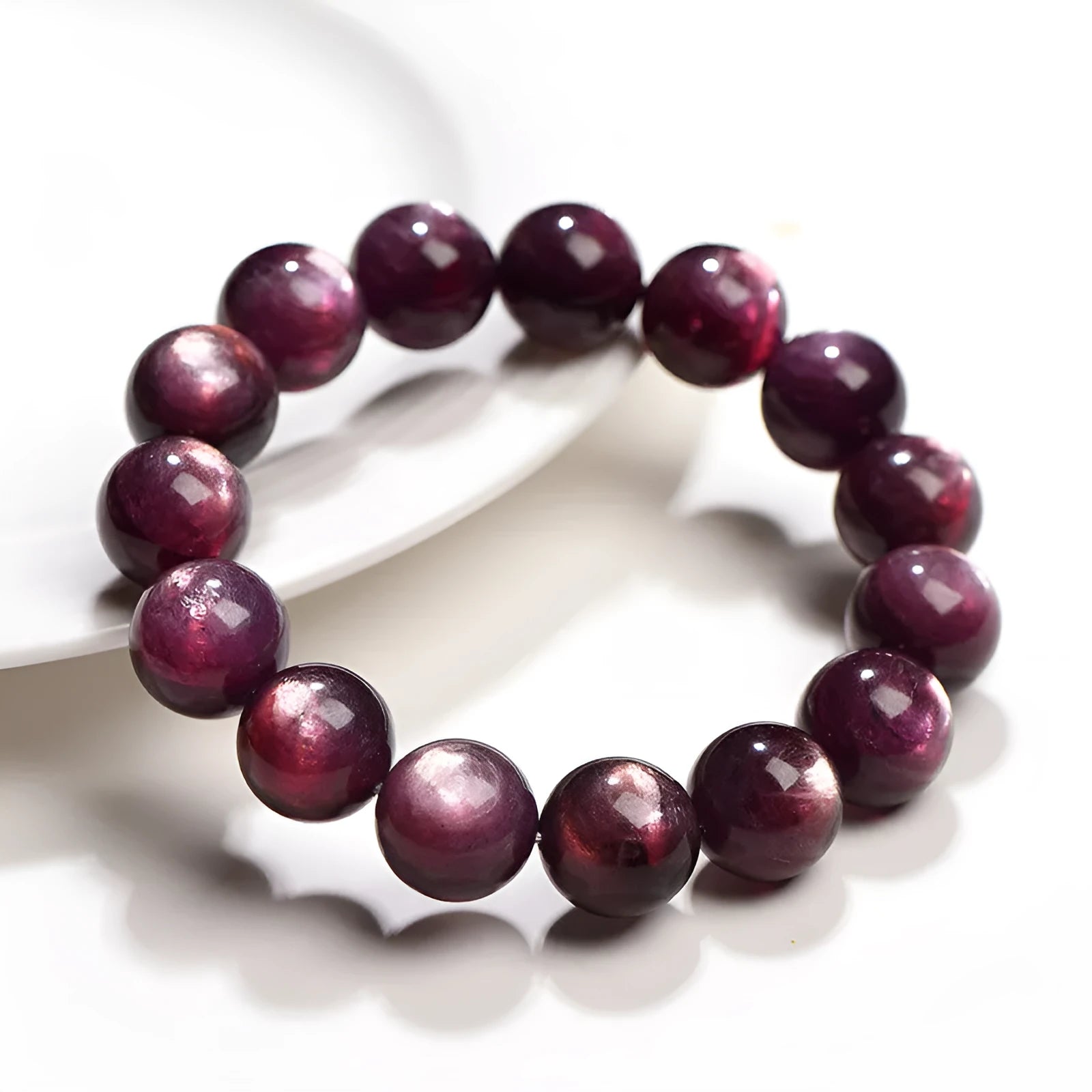 Natural purple lepidolite crystal round bead bracelet on a white background.