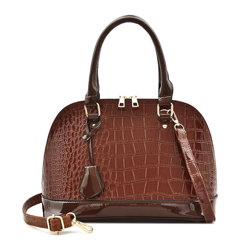 Shiny black PU leather crossbody shoulder bag with a structured shell shape