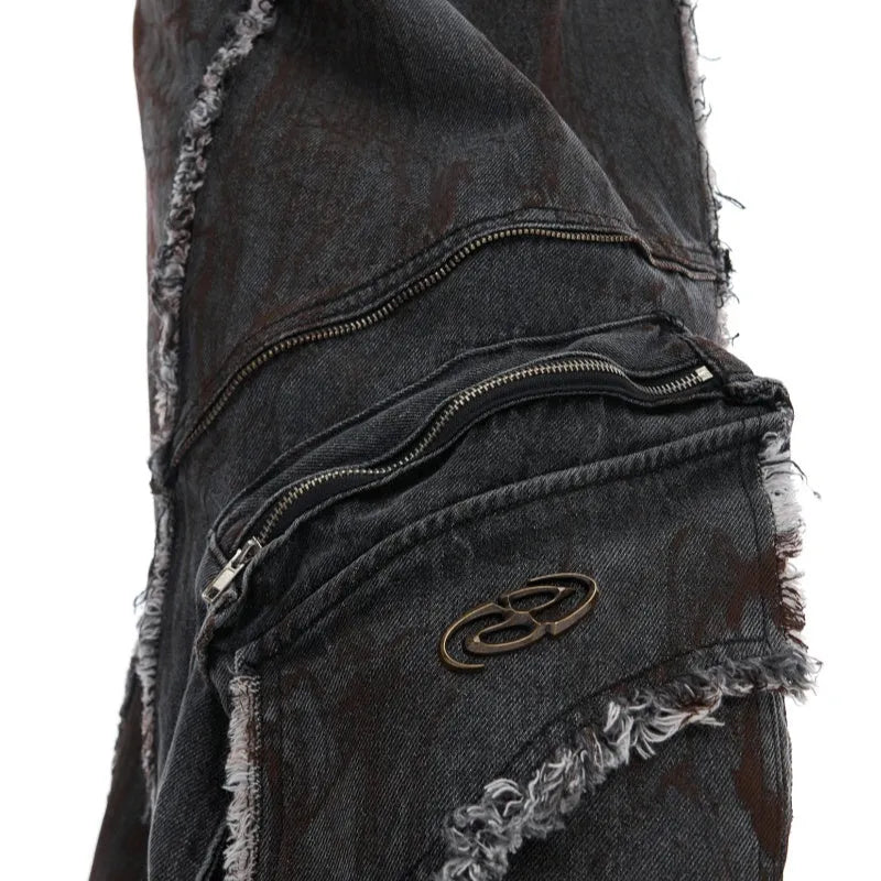 Black loose-fit denim jacket and trouser set with a splash-dye gradient pattern and padded shoulders.