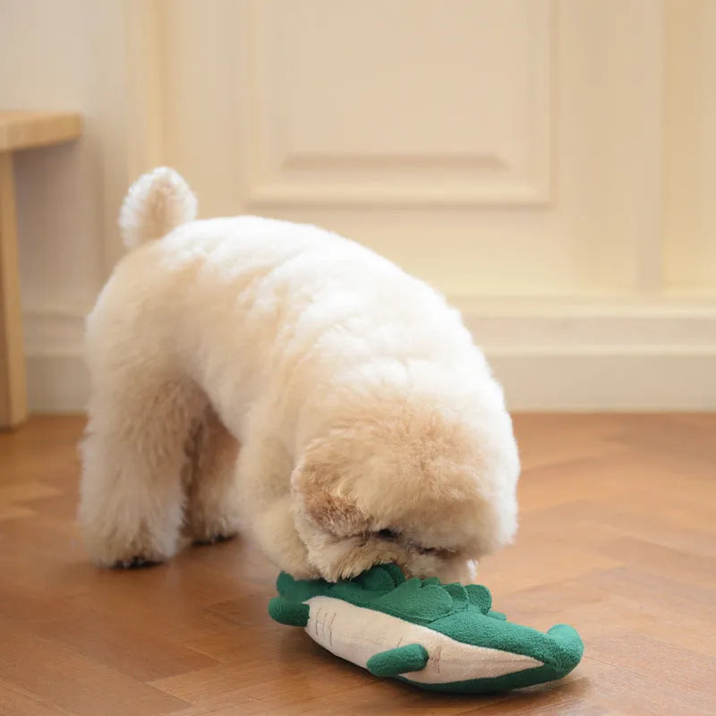 Green plush stuffed toy dog on white background, showing soft texture and size.
