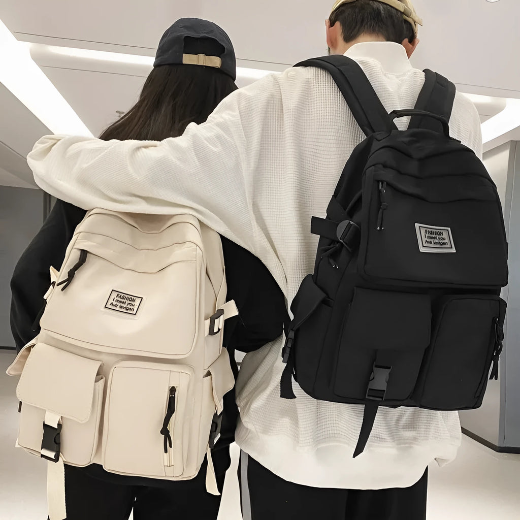 Black or white nylon student backpack with computer compartment measuring 31x12x41cm
