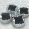 Colourful solar-powered LED valve light for mounting on a car or motorcycle wheel hub.