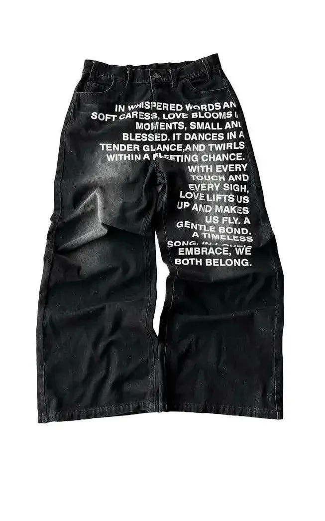 Men's loose-fit wide-leg straight trousers in black cotton fabric, laid flat to show the casual cut.