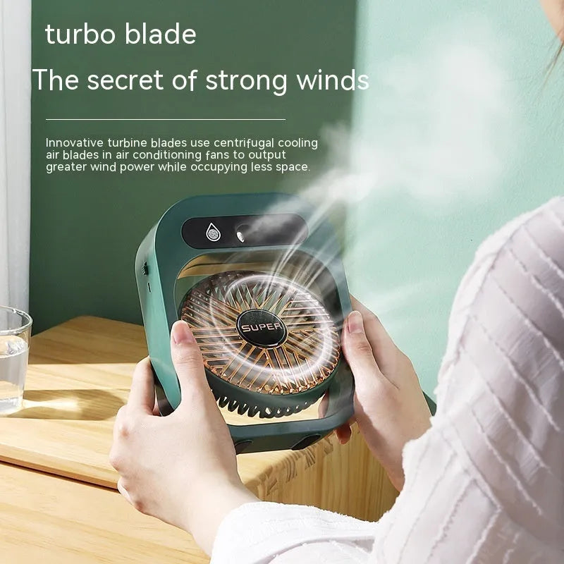 Green and white USB portable misting fan humidifier on a desk showing adjustable vent and water tank.