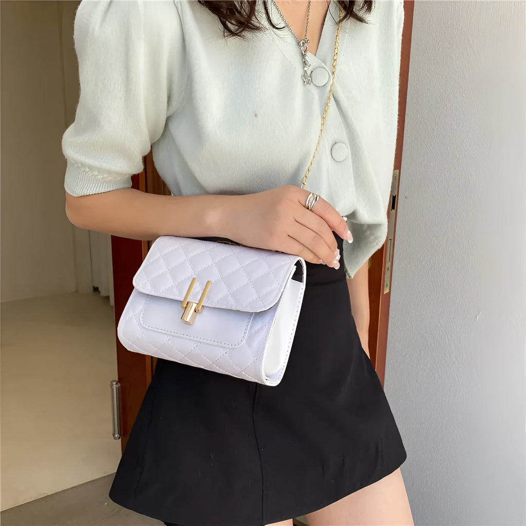 Women's crossbody bag with diamond lattice chain strap in black PU leather showing front view