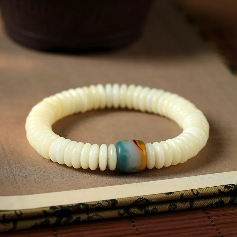 White Bodhi seed bracelet and handheld mala with 3x10mm beads on a neutral background.