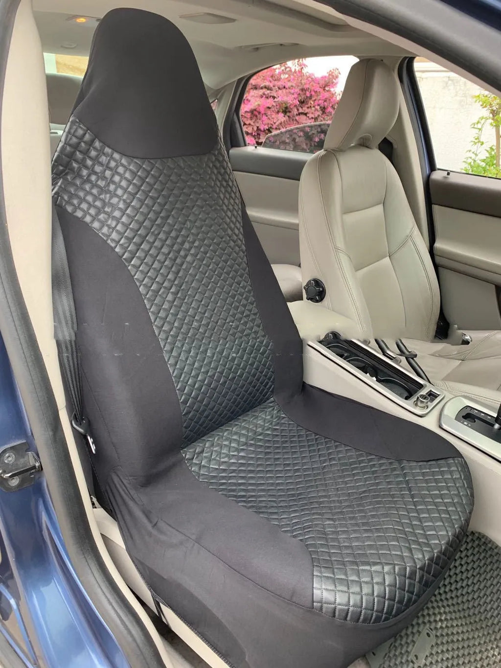 Black quilted universal car seat cover made from PU material on a car seat.