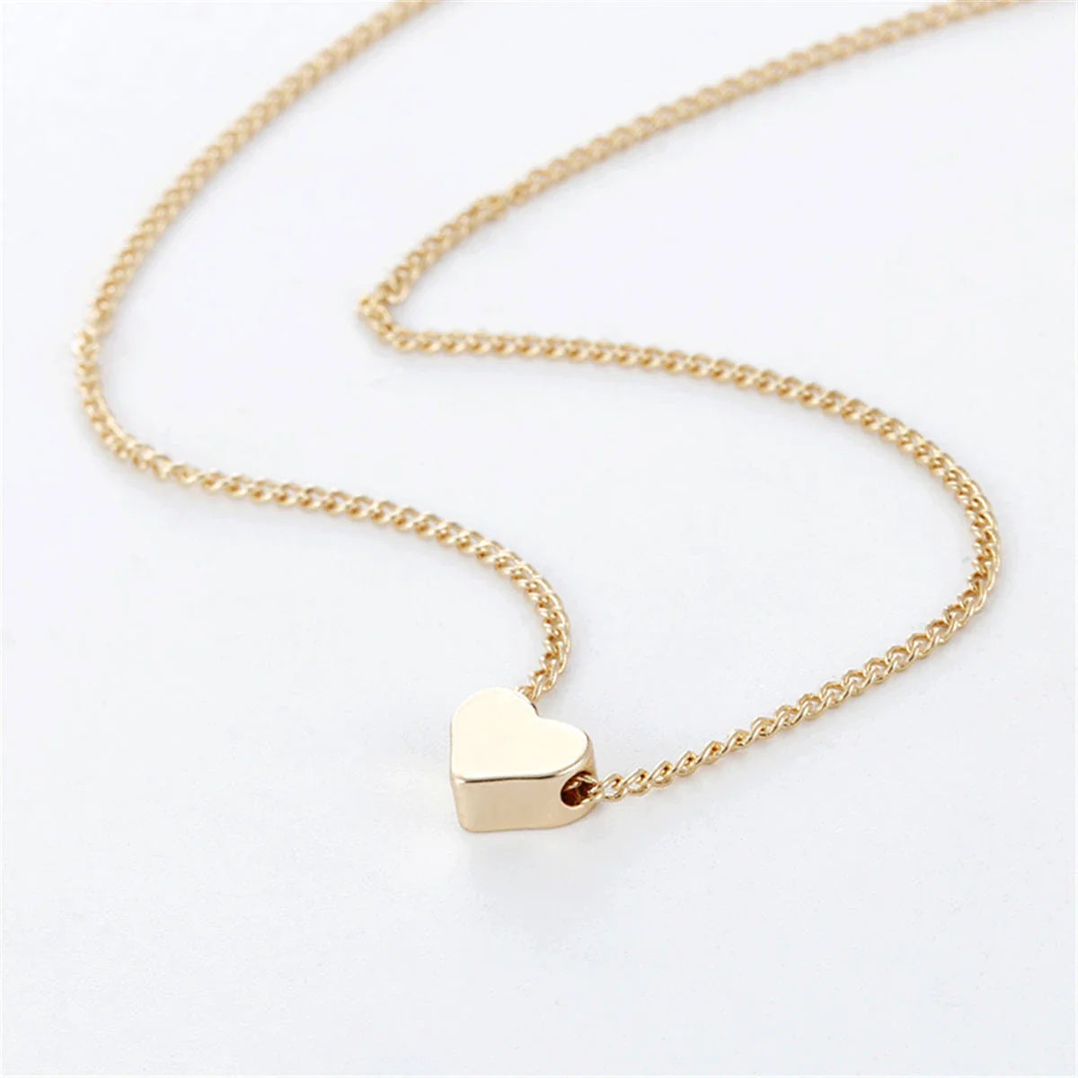 Elegant gold-tone double-sided love pendant necklace with clavicle chain, a versatile accessory for any outfit