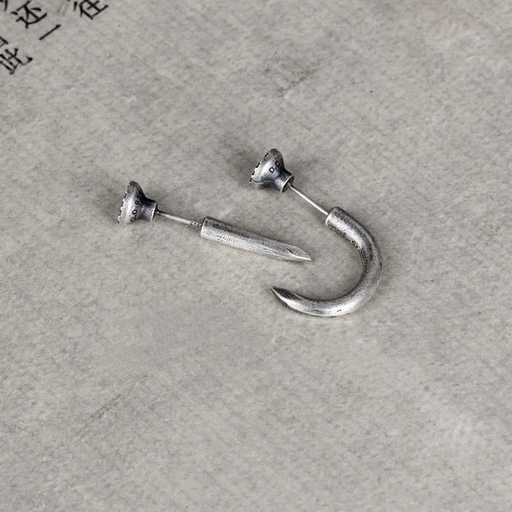 Sterling silver nail-shaped stud earrings with punk retro design