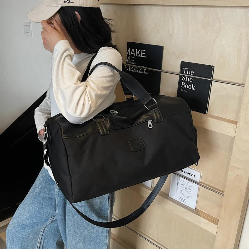 Large black travel messenger bag made from Oxford cloth with 36-55 litre capacity