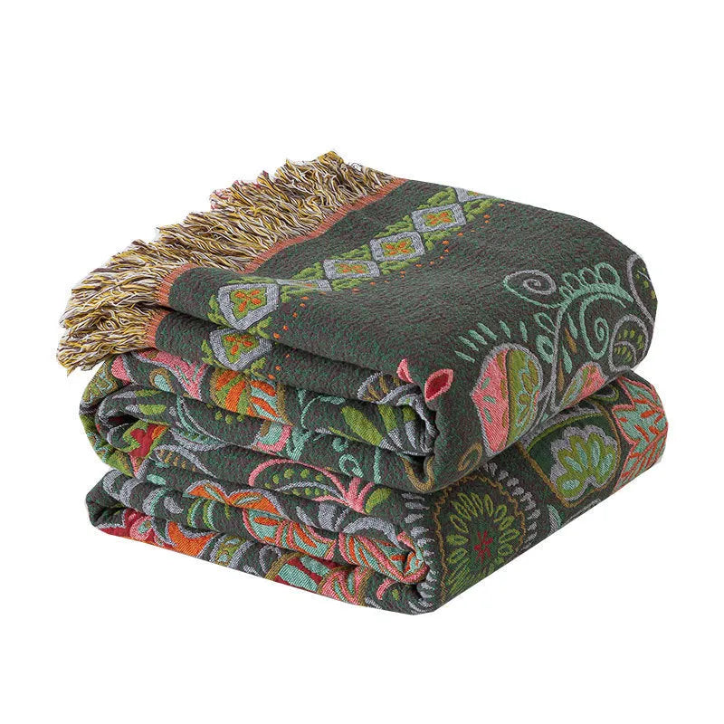 Cotton gauze towel quilt with tassels in beige flower pattern on a bed