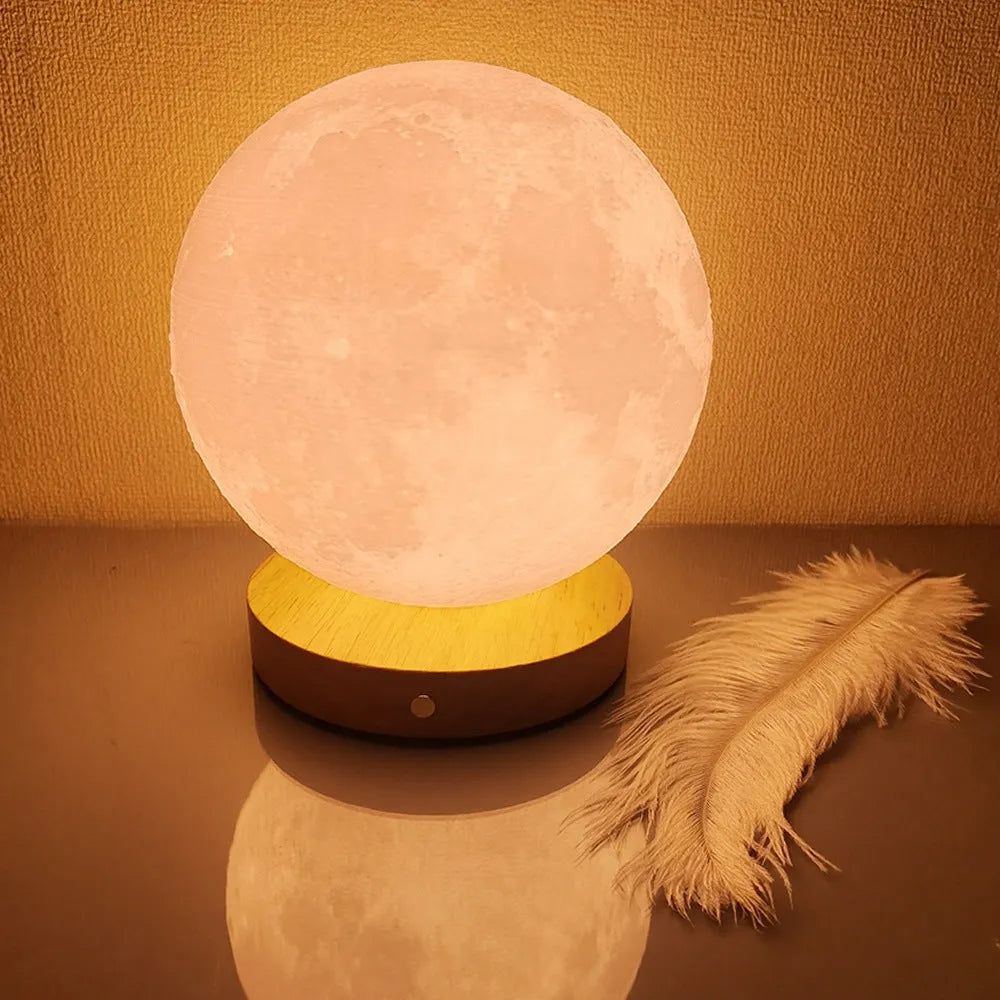 Rotating moon night light on a wooden base with a wire remote, shown in three available sizes.