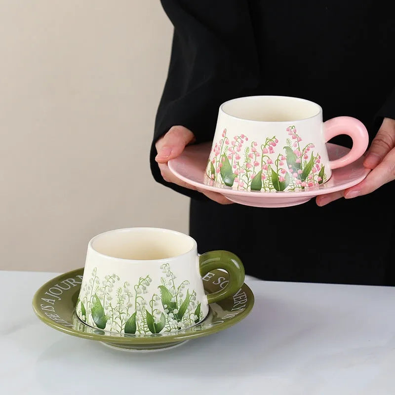 Ceramic coffee cup set with two mugs, saucers, and spoons in Campanula or Lanling Grass designs