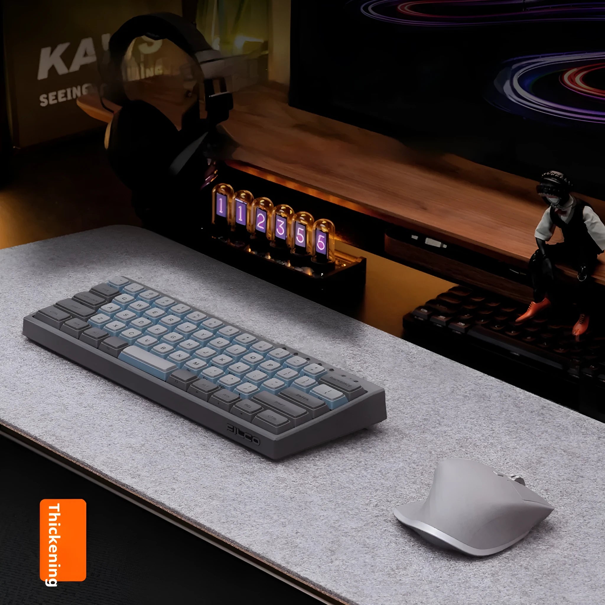 A grey and black felt cork desk mat with a mouse on it, shown on a wooden desk.