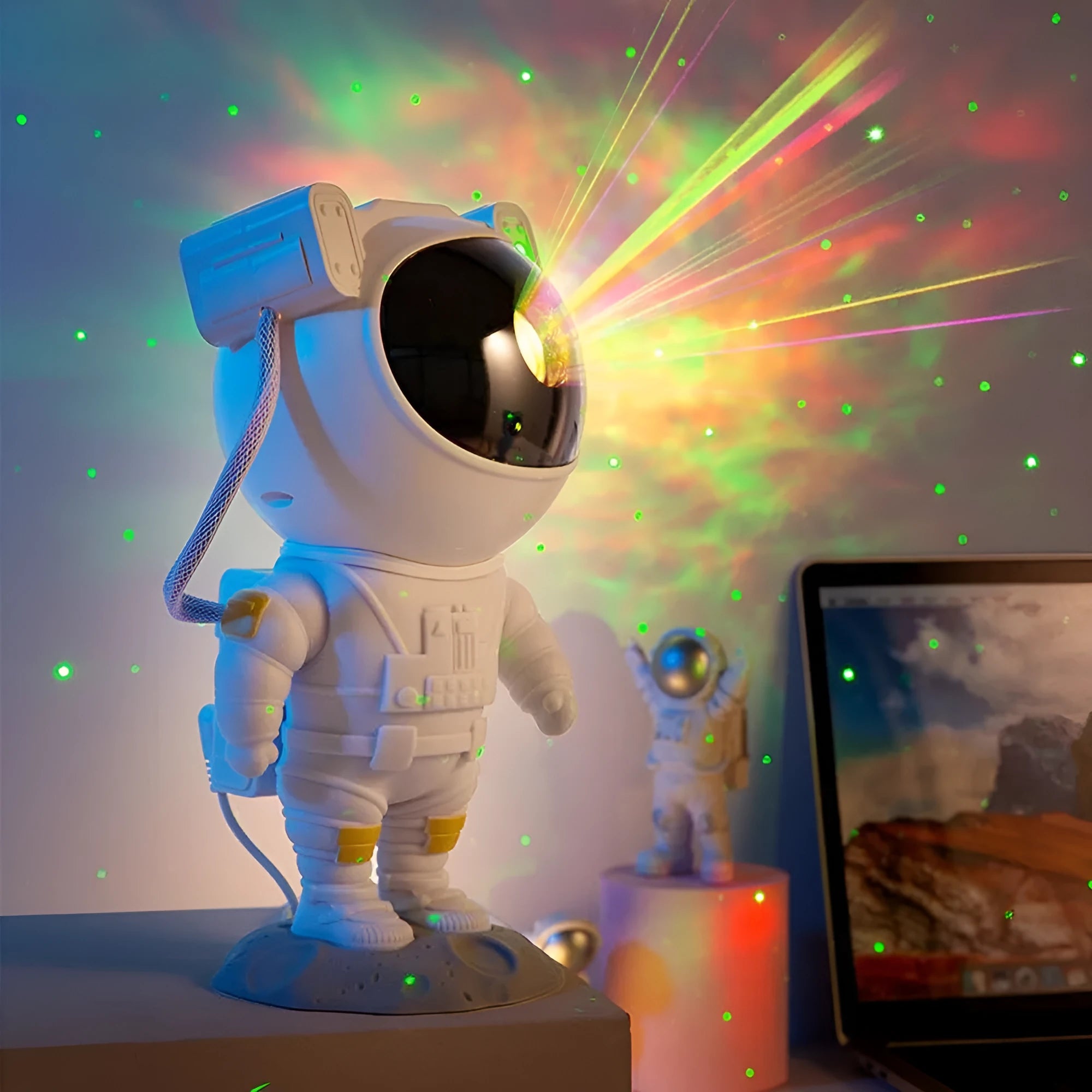 Creative astronaut galaxy starry sky projector nightlight on a table with nebula and star effects displayed against a dark background