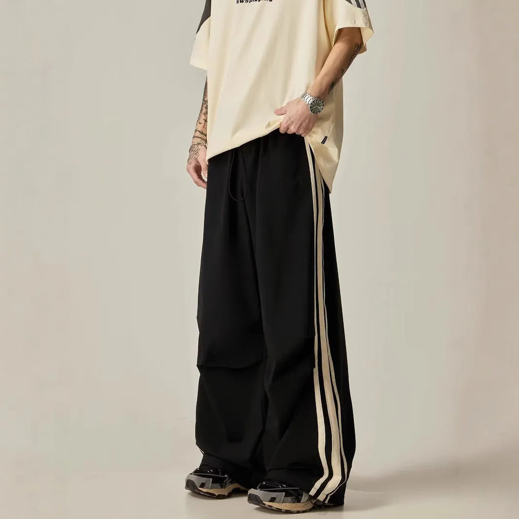 Men's black high-waist wide-leg climbing trousers with straight leg on a plain background.